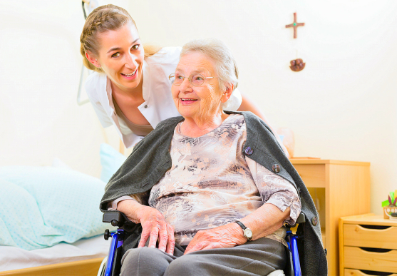 caregiver assisting senior woman on the wheelchair