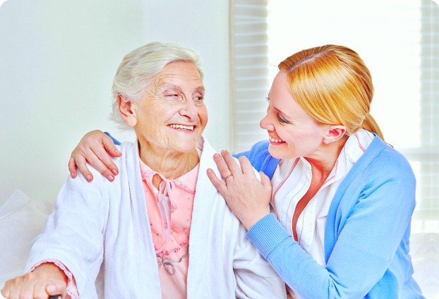 caregiver smiling to the senior woman